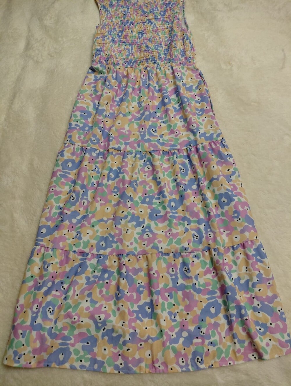 Women's floral print maxi dress with a smocked bodice, tiered skirt, and stretch